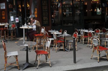 A man takes his lunch on a terrace at a restaurant, in Paris, Monday, June 15, 2020. Paris is rediscovering itself, as its cafes and restaurants reopen for the first time since the fast-spreading virus forced them to close their doors March 14. Restaurants outside the Paris region opened earlier this month, and Paris cafes were allowed to serve people outside but not open their doors. After three months of losses, some restaurateurs fear it will take a long time for business to come back. (AP Photo/Francois Mori)